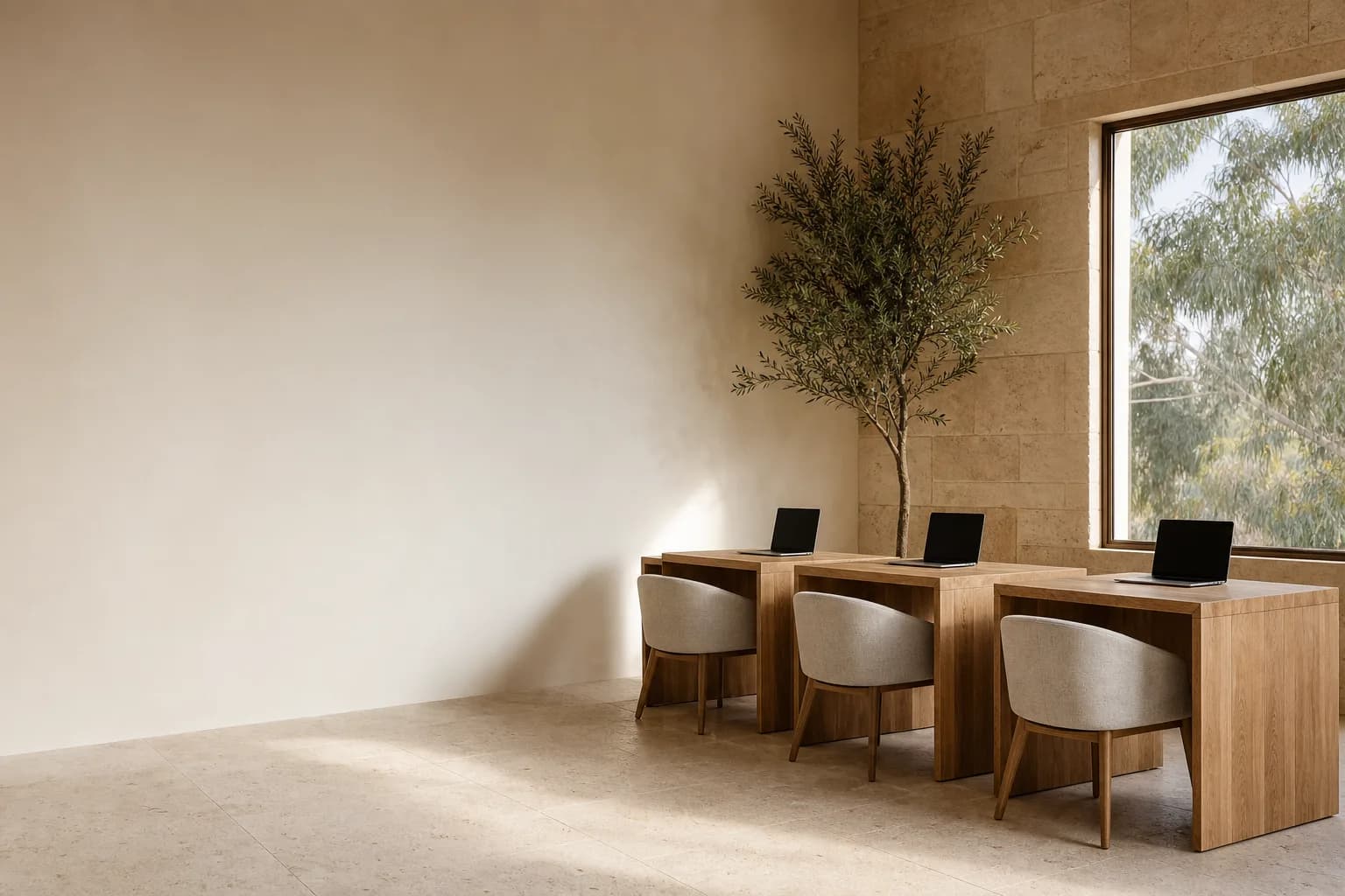 A small brokerage studio with three timber desks in morning light